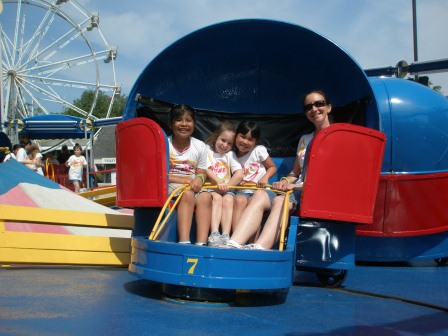 Mommy, Kasen and friends riding the Tilt-a-Whirl